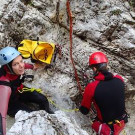 a man standing next to a pile of snow