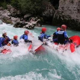 a group of people riding on a raft in the water