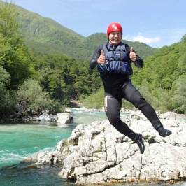 a man standing next to a body of water