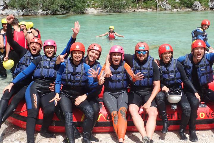 a group of people sitting on a raft in a body of water