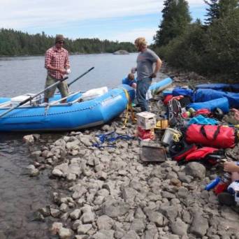a group of people on a raft in the sand