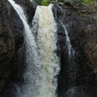 a large waterfall over some water