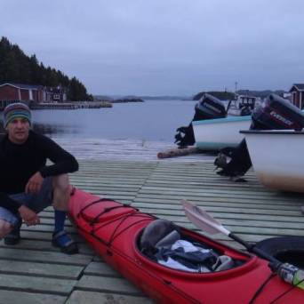 a man sitting on a boat in the water
