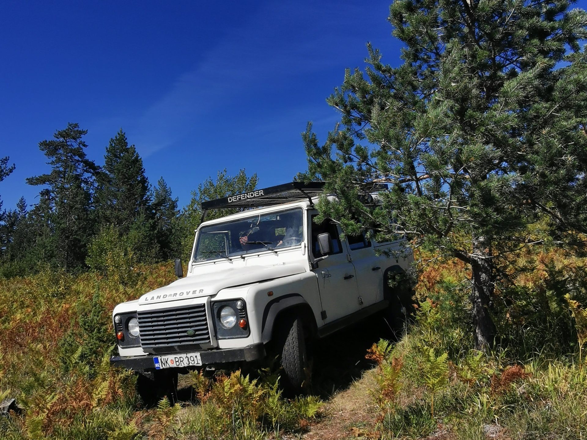 a truck parked on the side of a dirt field
