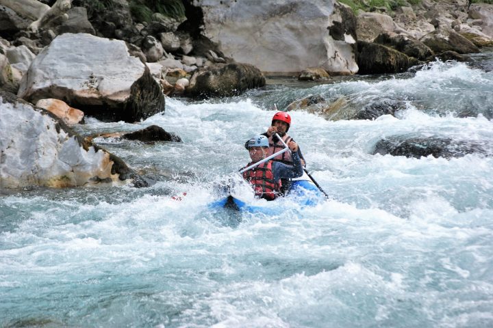 a man riding a wave on top of a rock