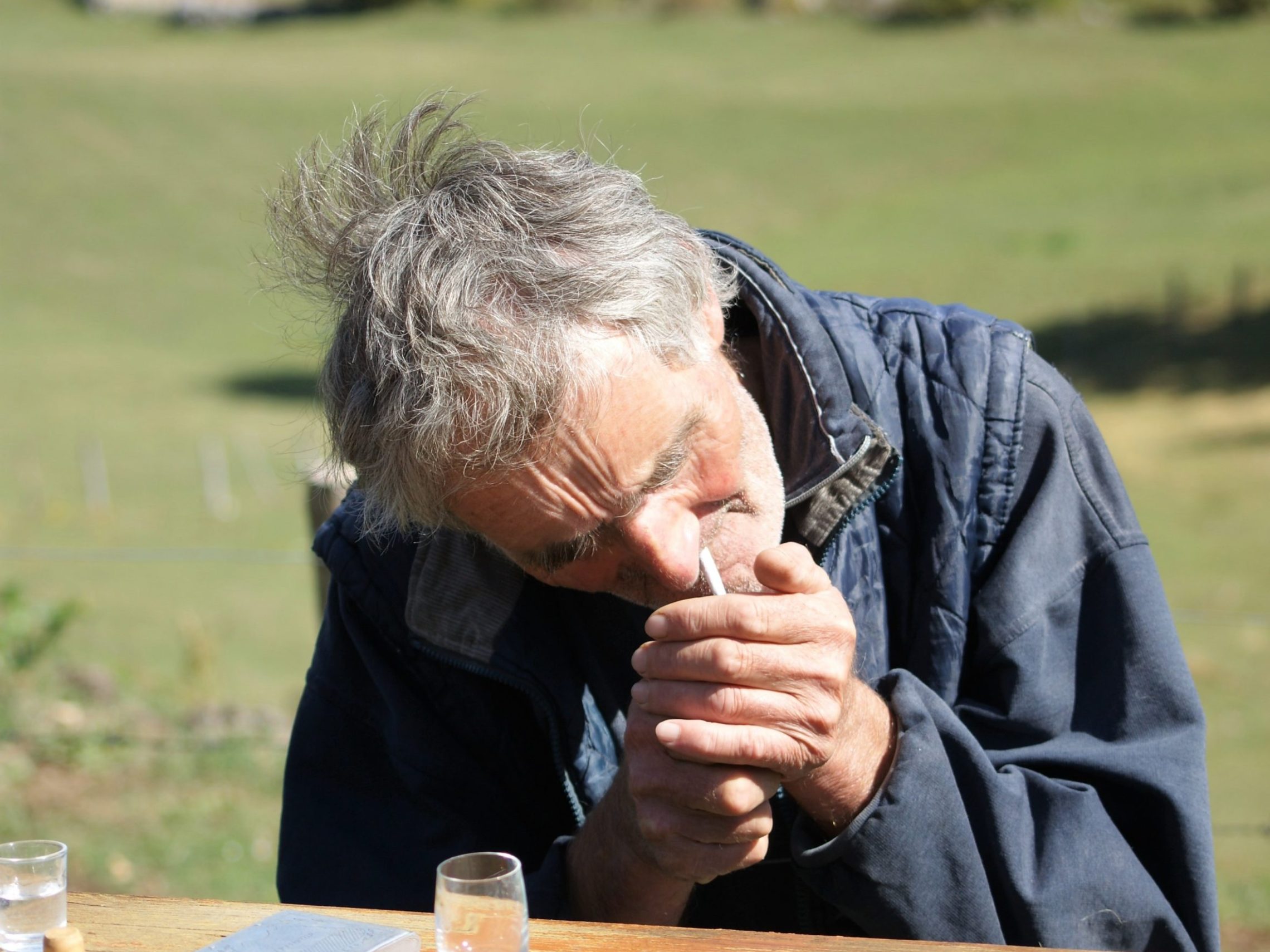 a person sitting at a picnic table