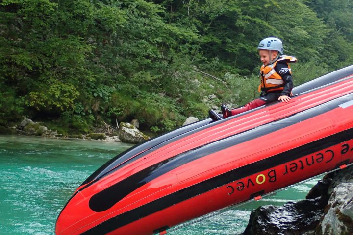 a person riding on the back of a boat in the water