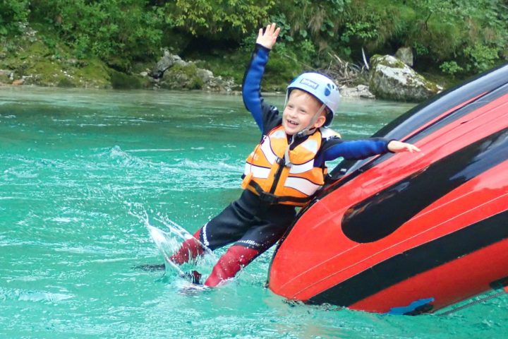 a man riding on the back of a boat in the water