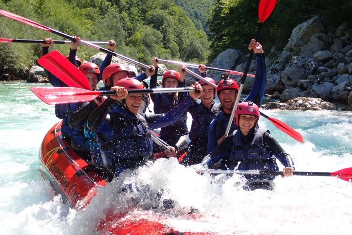 a group of people on a raft in the water