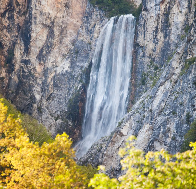 a large waterfall in a forest