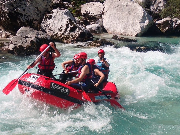 Heidar Headguide raftot kormányoz a Soča-folyón. IRF Trip Leader által vezetett vadvízi túra Bovecben.